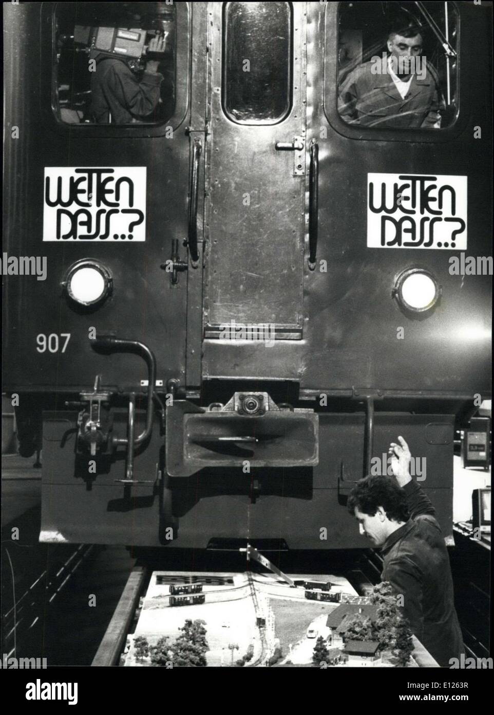 Apr. 11, 1989 - Delicacy of feeling ? ?Wetten, dass??, a German/Swiss TV Show, where people try to win the most ?impossible? and weird bets, presented something really special on Saturday April 09. Franz Oesch, a Swiss engine driver succeeded in connecting four tiny railway wagons with his big locomotive to their also tiny engine without damaging anything. Picture shows Oesch during this delicate action, assisted by his partner Hans Niederberger (right) Stock Photo