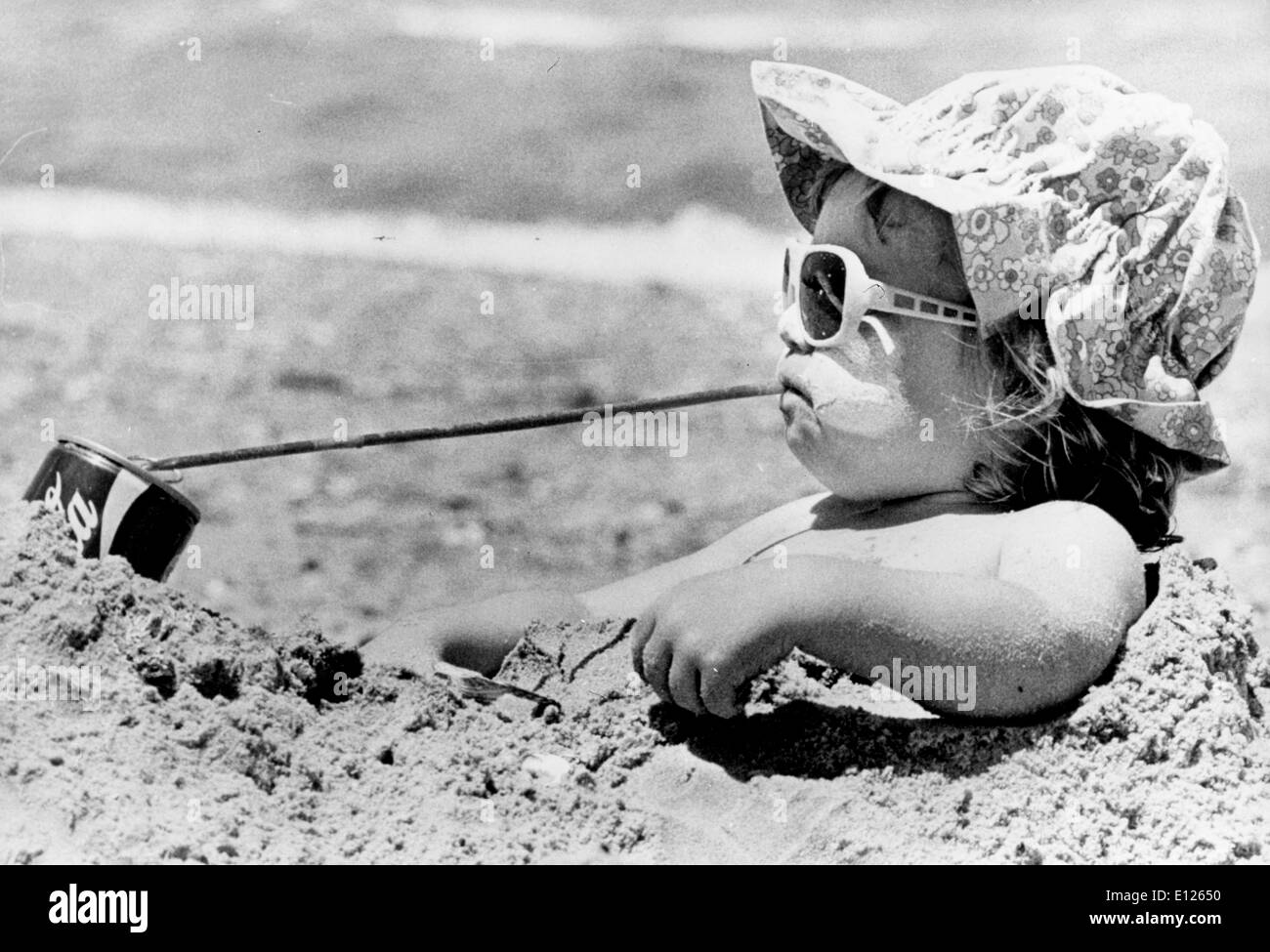 Jun 08, 1989; Melton, Australia; DANIELLE MARTIN is the first to agree that a cold drink can go a long way towards beating the heat. Danielle, from Melton, near Melbourne, Australia, at the beach as temperatures go into the 90's degrees. (Credit Image: KEYSTONE Pictures USA/ZUMAPRESS.com) Stock Photo