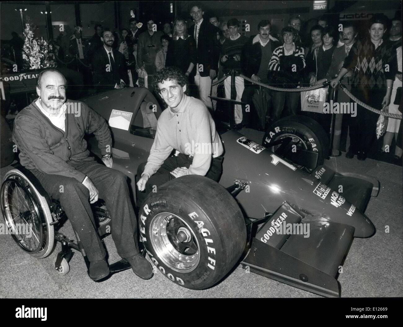 Nov. 11, 1989 - Prost, Regazzoni and Ferrari: Formula-One world champion French Alain Prost visited the racing-car exhibition ''Esposauto'' which was organized by former racing crack Swiss Clay Regazzoni. Photo shows Prost (right) sitting on a Ferrari racing car with the number 1 of the world champion, besides him Clay Regazzoni (left) Stock Photo
