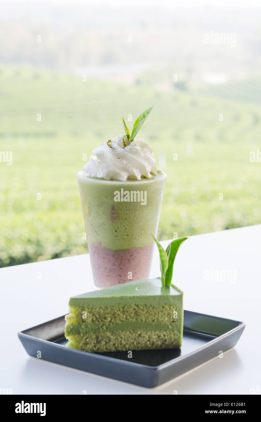 Green tea cake and smoothie with whipped cream Stock Photo