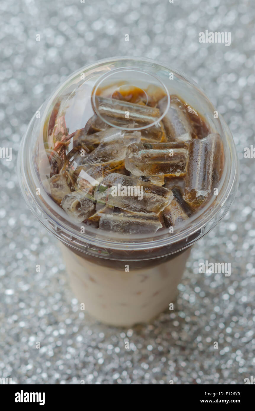 Iced cold coffee latte in plastic cup isolated on white background,  clipping path included. Stock Photo