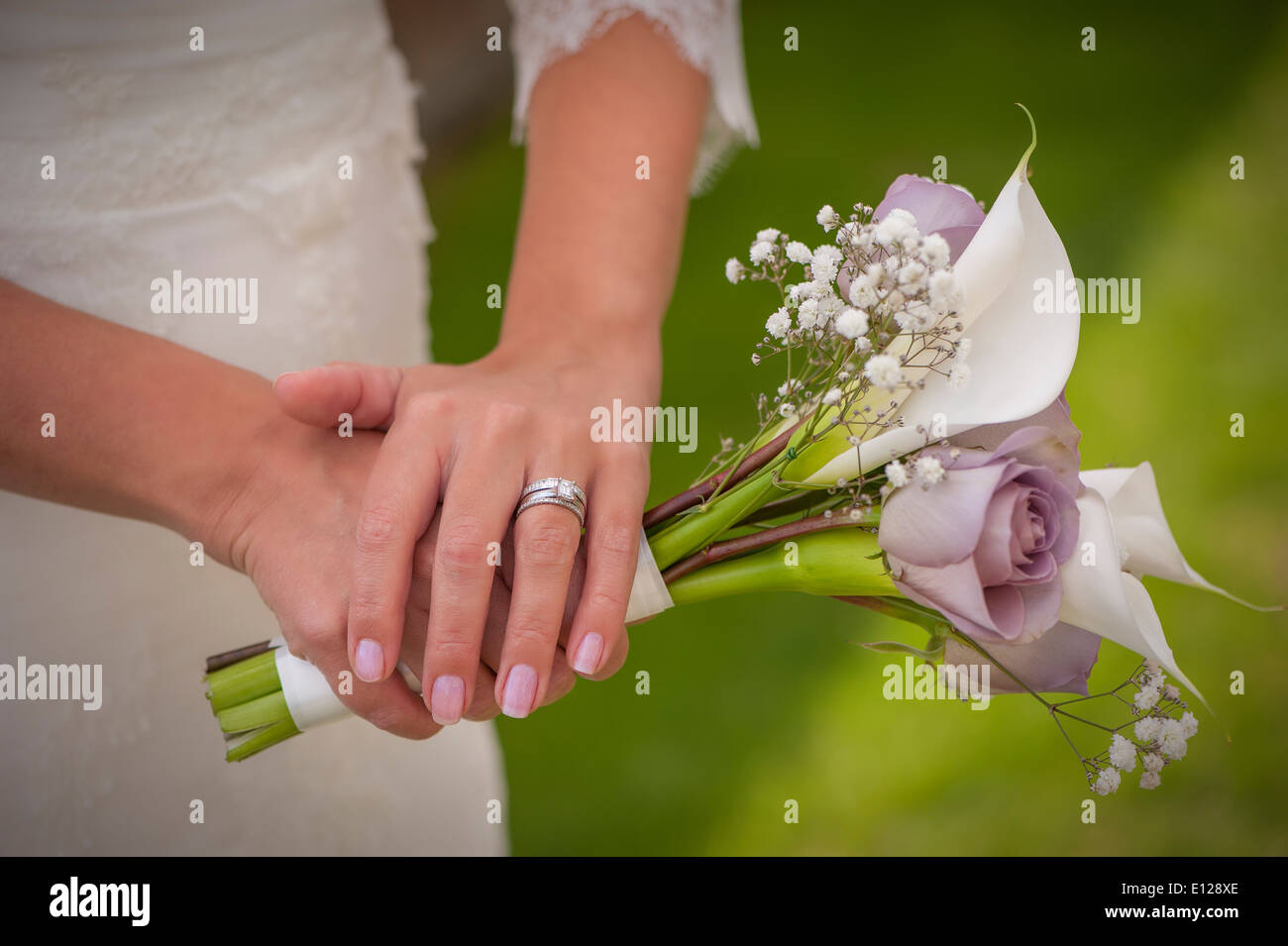 brides flowers in hand showing wedding ring Stock Photo Alamy