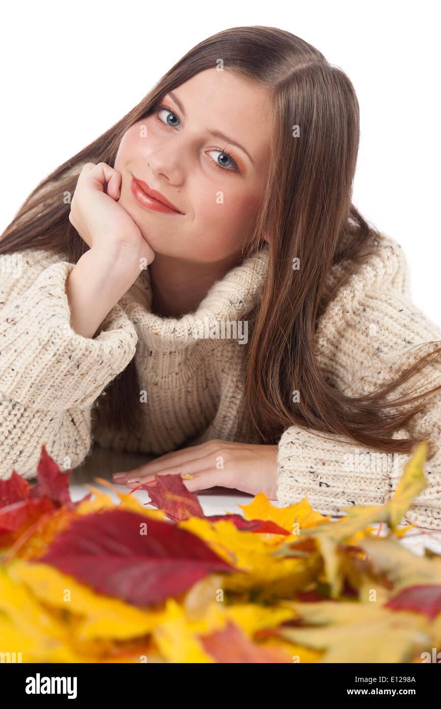 Oct. 29, 2009 - Oct. 29, 2009 - Autumn portrait of beautiful woman with leaf wearing turtleneck on white background Imag Stock Photo