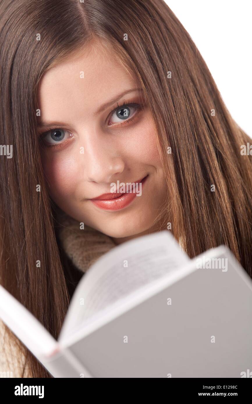 Oct. 29, 2009 - Oct. 29, 2009 - Portrait of young happy woman with book wearing turtleneck on white background Ã‚ Stock Photo
