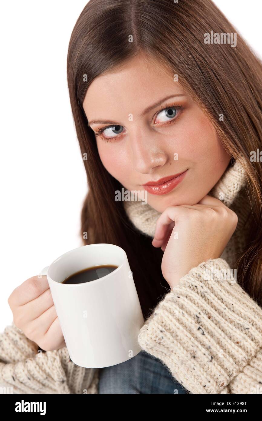 Oct. 29, 2009 - Oct. 29, 2009 - Winter portrait of happy woman holding cup of coffee wearing turtleneck on white : Stock Photo