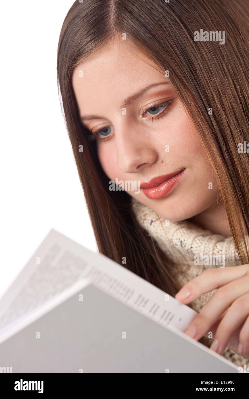 Oct. 29, 2009 - Oct. 29, 2009 - Portrait of young happy woman with book wearing turtleneck on white background Ã‚ Stock Photo