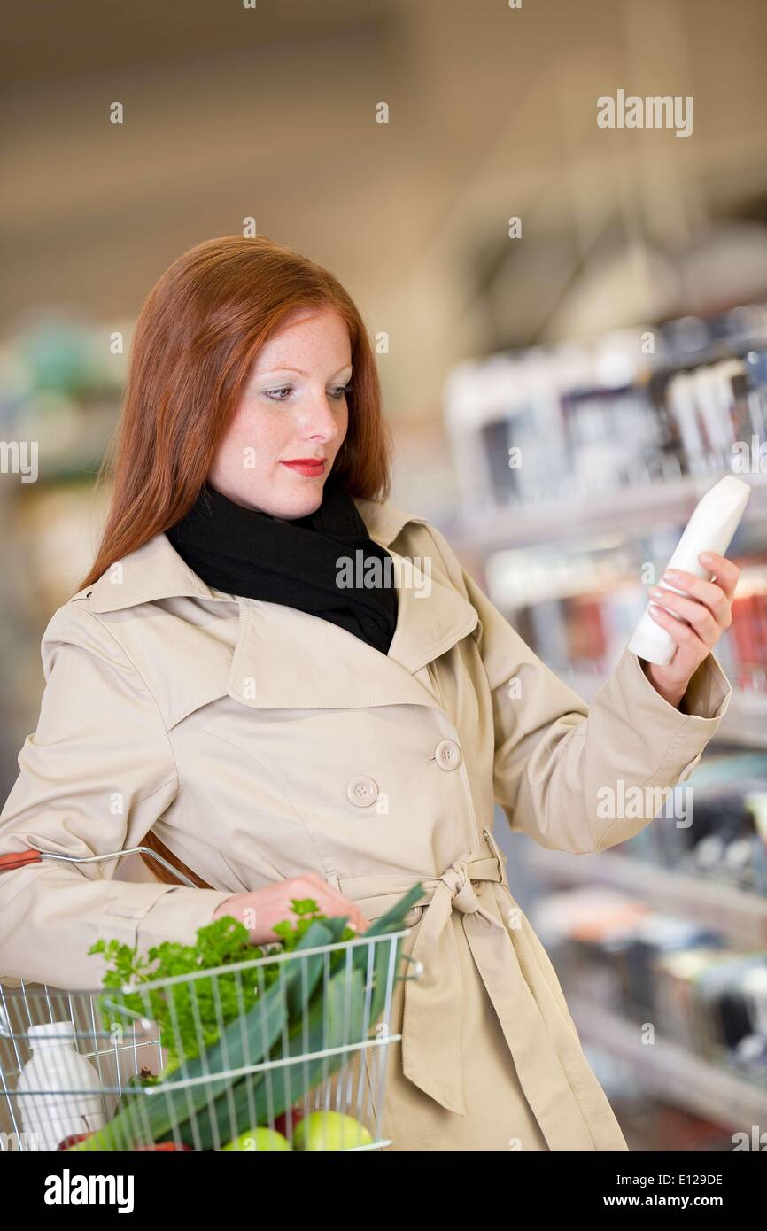 Apr. 18, 2009 - April 18, 2009 - Red hair woman buying shampoo in supermarket Stock Photo