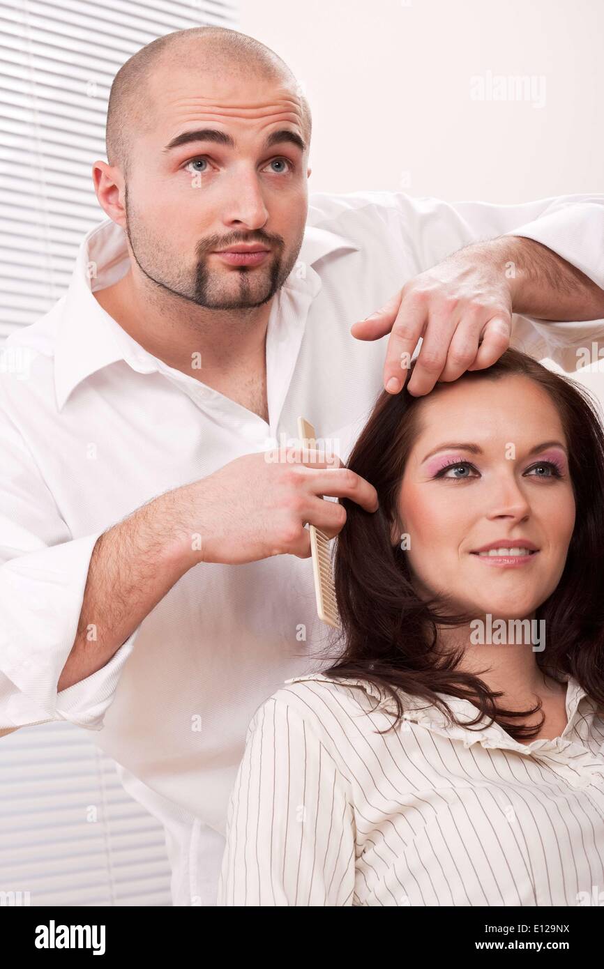 Jan. 30, 2010 - Jan. 30, 2010 - Professional male hairdresser comb female customer at salon Ã‚Â© CTK/ZUMAPR Stock Photo