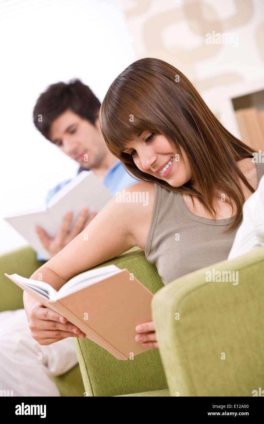 Apr. 17, 2010 - April 17, 2010 - Student - two teenager reading book in lounge, sitting on armchair Stock Photo