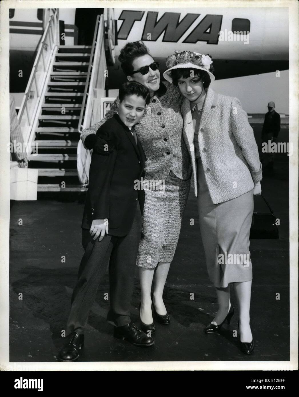 Dec. 09, 2011 - Idlewild Airport, N.Y., April 22 - Ethel Merman, star of the Broadway hit ''Happy Hunting'', bids farewell to her youngsters Ethel, 14, and Bobby, 11, as they board a TWA Constellation for an easter vacation visit to Denver. They'll return to their studies in New York next week. Stock Photo