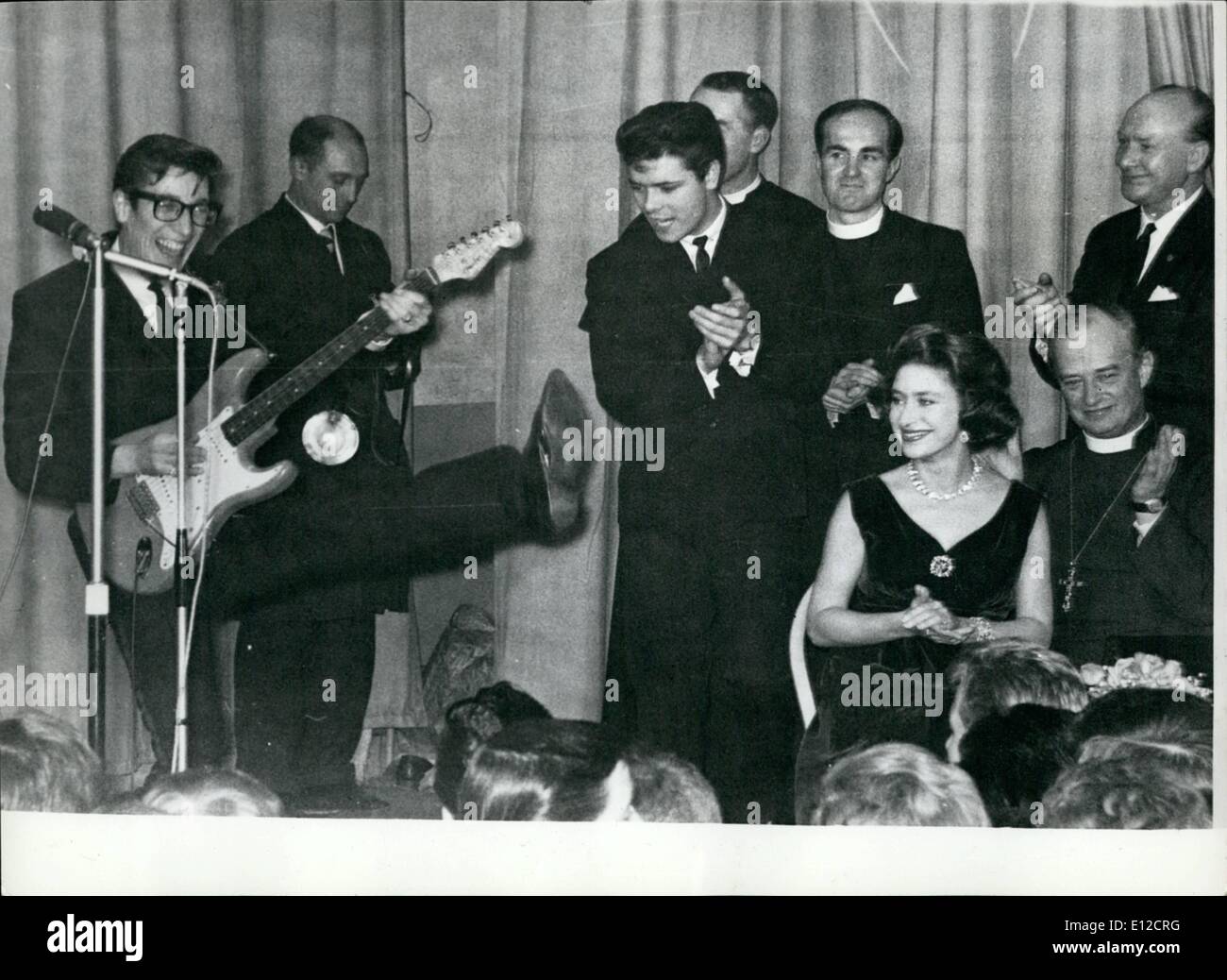 Dec. 16, 2011 - Cliff Richard With Princess Margaret - and they both join in clapping to the guitar of Hank Marvin of The Shadows. The Princess was visiting a youth club in the East End of London. Stock Photo