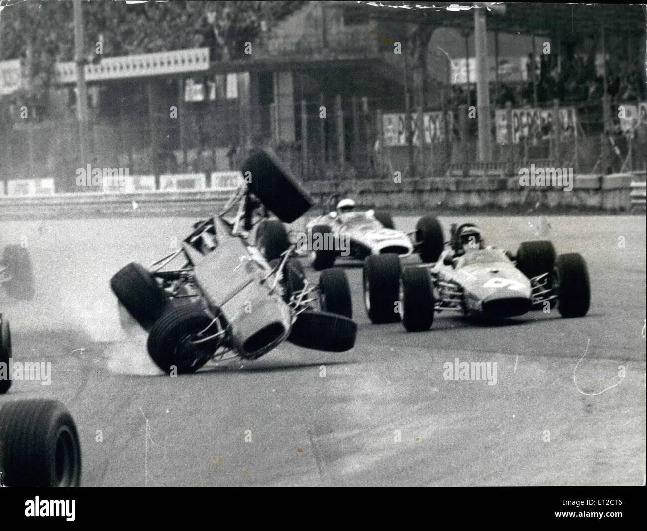 Dec. 16, 2011 - Italian Driver Pino Pica Will not Easily Forget the ''Grand Prix Campagnola'' - a Formula 3 race at Monza, Italy - for in the second heat he had a most amazing escape when his car hurled over another car and landed upside down over the guard rail. Pica was unhurt, but when shown the remains of his car her fainted with shock, and was taken to hospital. Photo Shows:- A Striking Picture as Pica's Car Begins its Fantastic Jump- During the Race at Monza. Stock Photo
