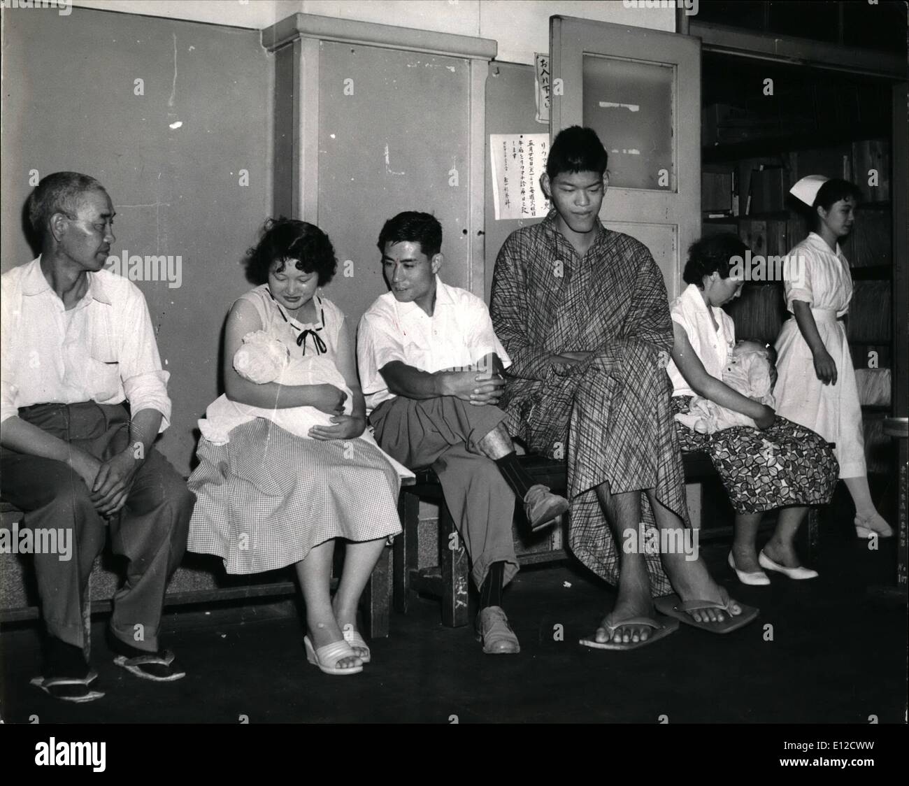 Dec. 12, 2011 - The giant patient sits outside a doctor's clinic in the Tokyo Universuty Hospital where jhe is undergoing treatment. Doctors Try to Stop Him Crowing Seven Feet Nine Inches, And Yoshimiitsu Still, Crows: Yoshimitau Matsu Matsuzaka, 22-year-old farmer's son just can't stop growing. Already he is 7 ft. 9 ins. and weighs 255 lbs Stock Photo