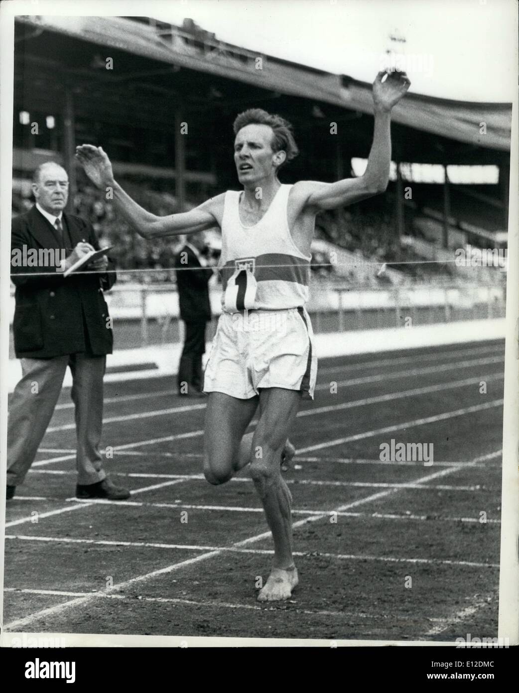 Dec. 19, 2011 - Tulloh Wins White City Three Miles Barefoot Bruce TRulloh throws up his arms as he wins the theww miles event of the Amateur Athletic Association Championships at the White City Stadium, London, July 13. Tulloh's time was 13 minutes 23.8 seconds. Stock Photo