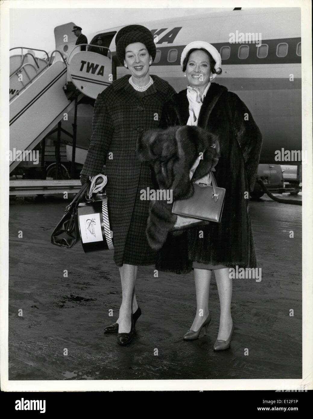 Dec. 21, 2011 - Two of Hollywood's great names Rosalind Russell, Left, and Merle Oberon Grace the Cameraman's lens as they prepare to board a TWA Super jet for Los Angeles. Miss Russell, who is Mrs. Fred Brisson in real life, was in town for her producer-Husband's Broadway opening of ''Under the Yum Yum tree''. Miss Oberon, married to wealthy European Businessman Bruno Pagliai will make her home in Hollywood for awhile after living on the continent. Stock Photo