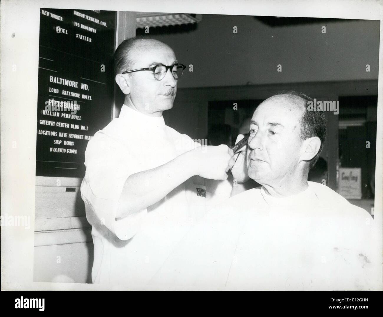 Dec. 26, 2011 - Adlai Stevenson between two engagements during the 1952 election campaign takes a haircut in the RR terminal barbershop. Stock Photo