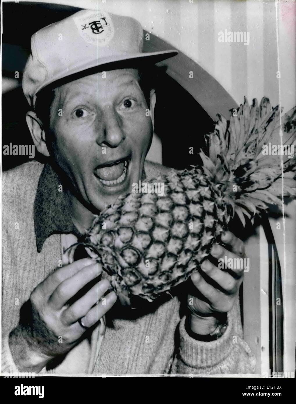 Jan. 04, 2012 - Danny Kaye Has Fun - at Australian Zoo... Takes a Bite at a Pineapple. The fur really began to fly - when popular film comedian Danny Kaye recently paid a visit to Taronga Zoo, Sydney - during his recent trip to Sydney, Australia. It started off with an impromptu 'carrot' fight between Danny and the Gorilla ''King Kong'' - and ended up by an exchange of half ripe pineapples... Here is Danny - as he takes a bite at his pineapple - the gift from the Taronga Zoo ''King Kong' Stock Photo