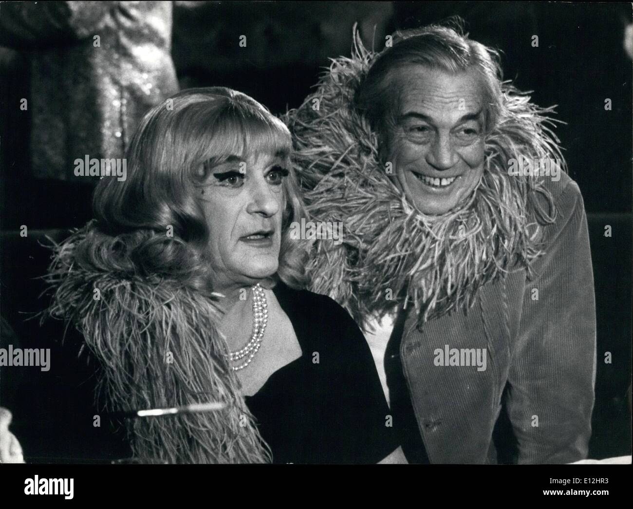 Jan. 09, 2012 - Do you recognize this blonde and sturdy woman?? She (or beer he) is the Academy Award winning star George Sanders, 63, who played the most unusual scene of his long career as a transvestite nightclub performer who double as a crack espionage agent in ''The Kremlin Letter'', new spy thriller directed by John Huston now filming in Rome. Dressed in black sheath gown, a gold choker at his throat and a multi colored feather boa around his shoulders, Sanders in blonde wig and full make-up was filmed playing the piano to an admiring host of fellow inverts in a key sequence Stock Photo