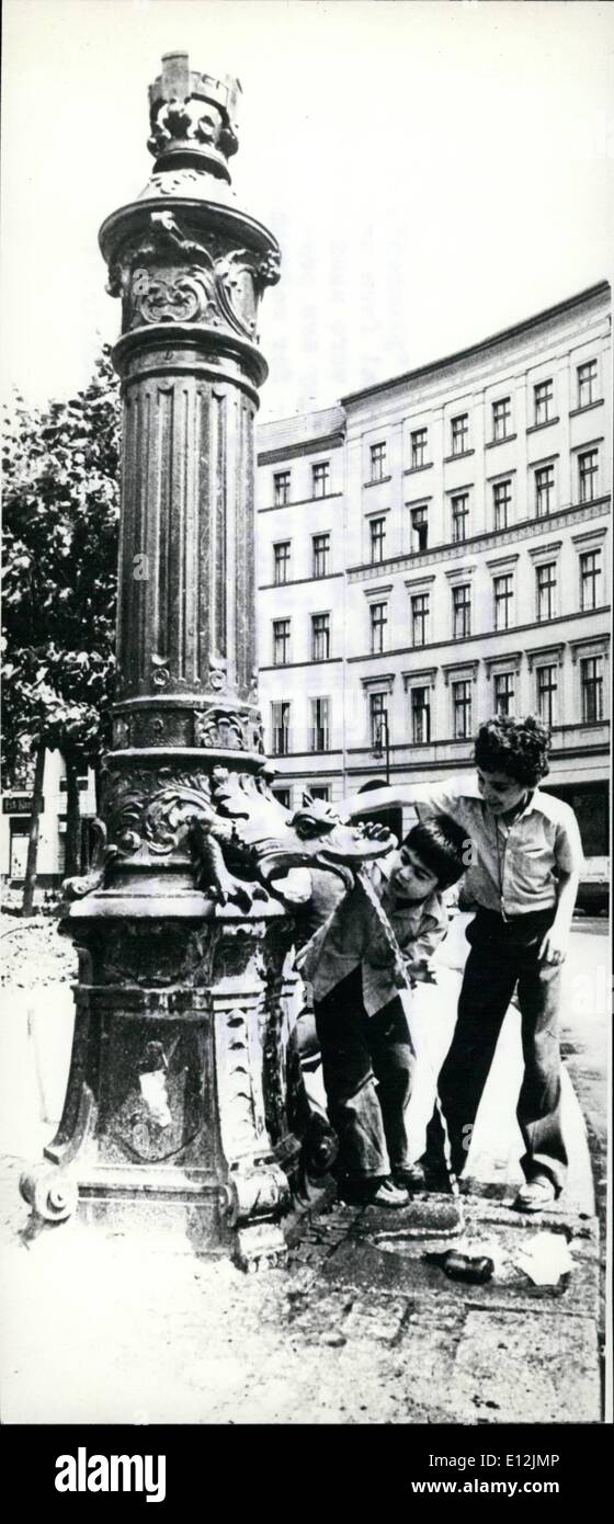 Feb. 24, 2012 - A typical Berlin street scene: Everywhere in Berlin there are to see such ''plumpen'', either presenting themselves in a historical form or also in a very modern look. Earlier these were used as watering place for horses, nowadays they are preferred for car washing or in hot days for refreshment (specially for children like here). For the Berlin Waterworks and ''plumpen'' are spare pipes for the emergency. Stock Photo