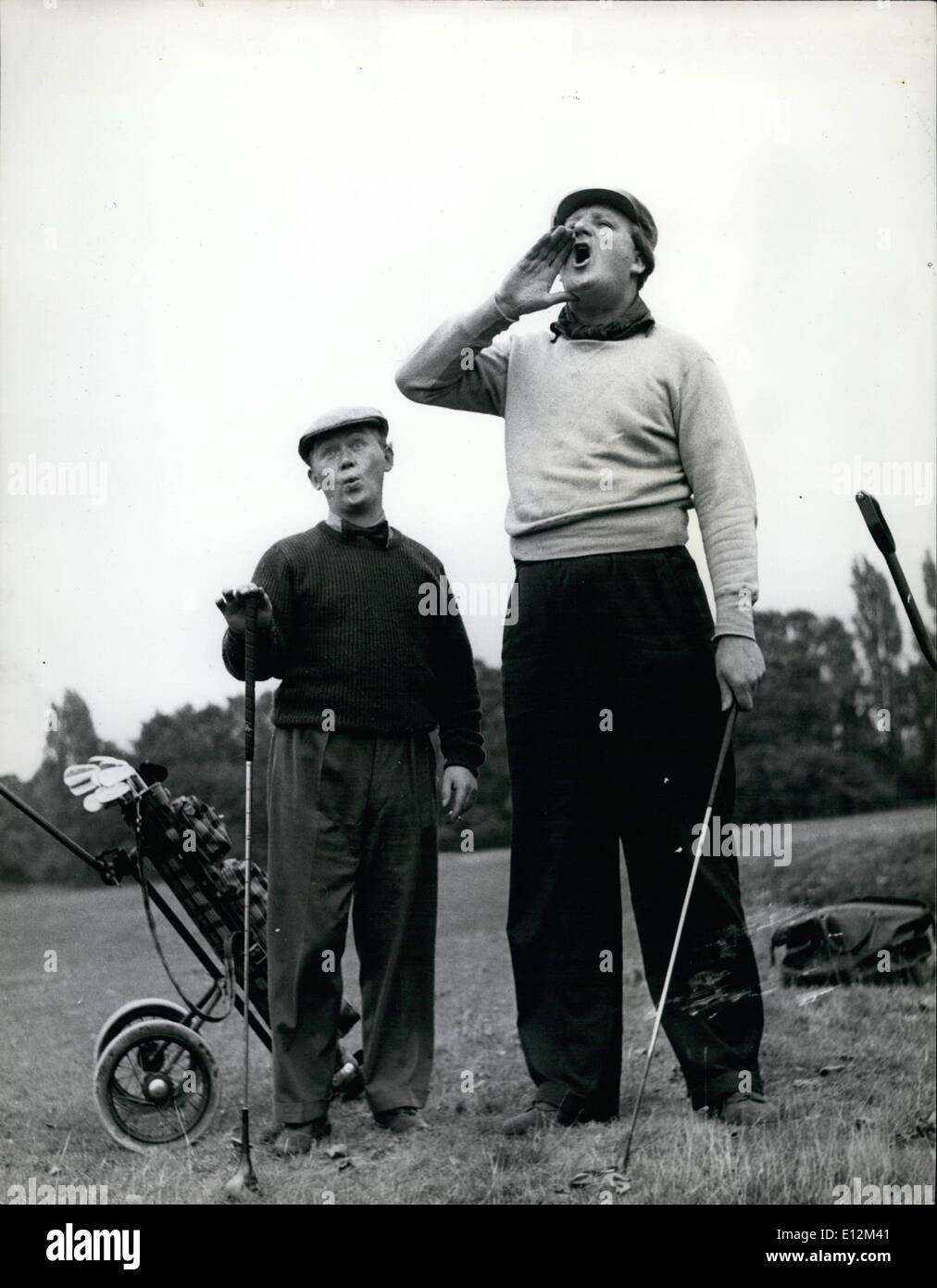 Feb. 24, 2012 - While Jack Edwards shouts ''fore'', his diminutive partner Charlie Drake thinks 'two' is good enough for him as Stock Photo