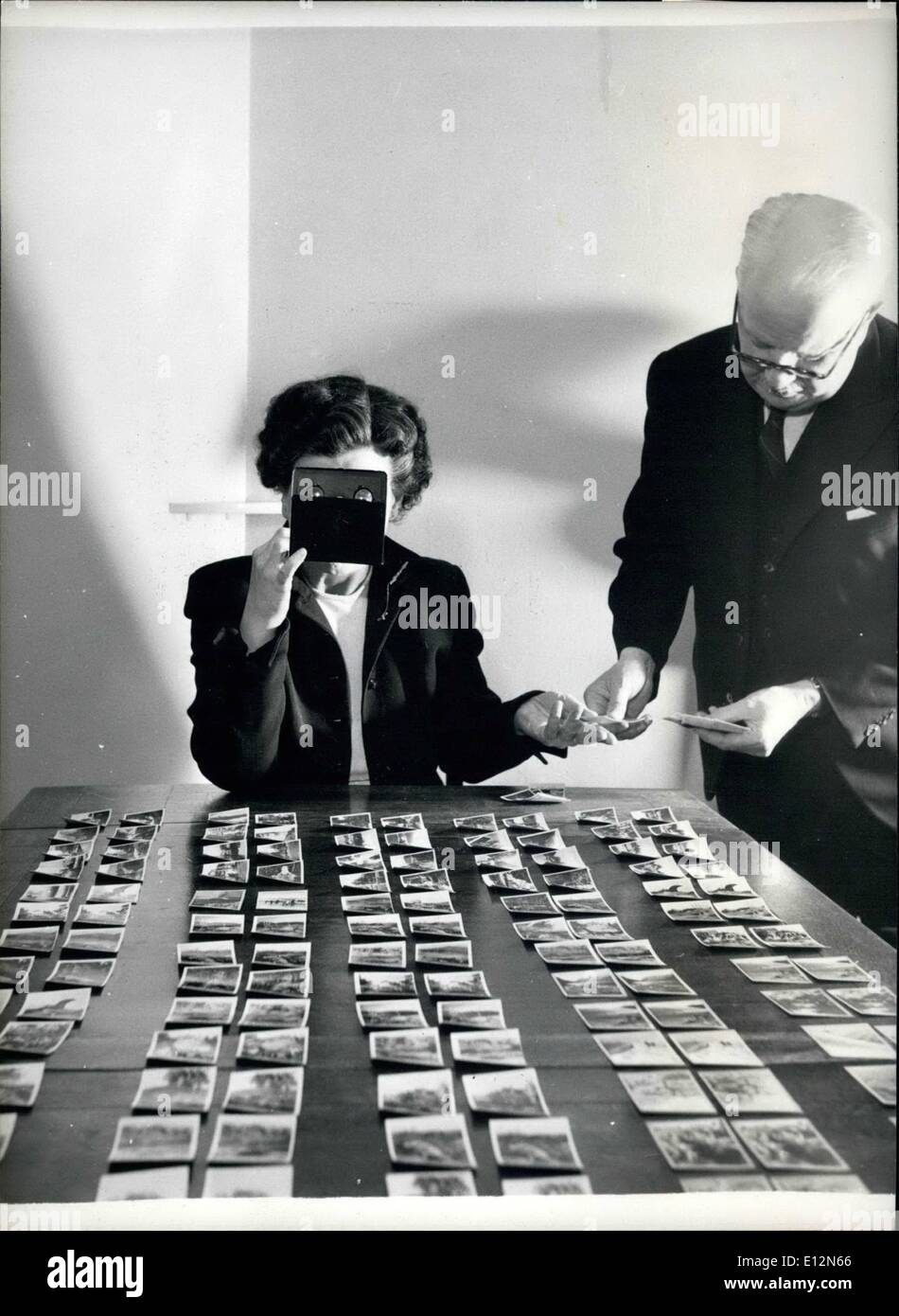 Feb. 24, 2012 - Stereoscopic cigarette cards. A rarity among cigarette card, stereoscopic pairs which were issued before the war in America. All the real photographs. Colonel Bagnall's daughter Dorothy, is viewing them through a stereoscope. Stock Photo