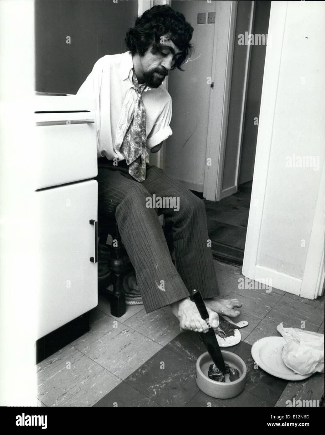 Feb. 24, 2012 - In the kitchen of his nest semi-detached house in Birmingham, Frank Letch cuts up some meat for his dog. Stock Photo