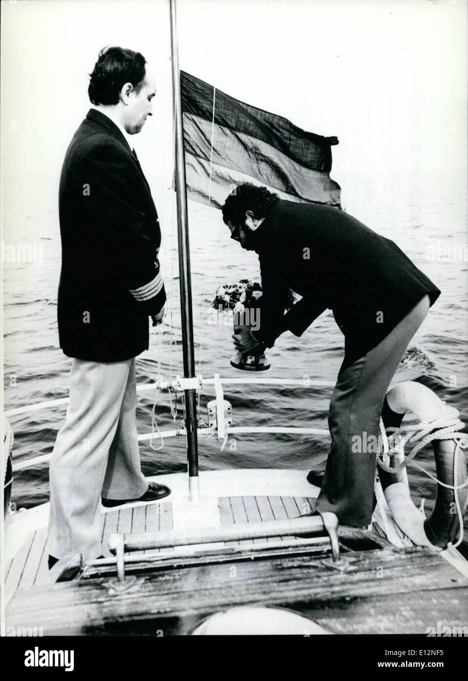 Feb. 24, 2012 - First German sea undertaker's proves to be successful: The ashes of a person, who had wished to be buried at sea are seen being lowered into the water by a co-worker of the first ''German Shipping-Firm for Sea Burials''(picture). Being one year in business now, the firm has proved to be rather successful many urns have already been sent to the bottom of the Nort or Baltic Sea and about one thousand people have declared to be buried at sea after they will have died Stock Photo