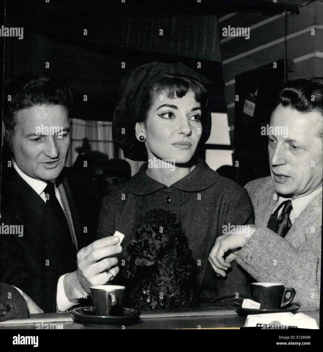 Feb. 24, 2012 - Maria Callas leaves Paris: The famous Prima Dona, Maria Callas left Paris this afternoon, she is going back to Milan. N.P.M in Orly, at the aerodrome bar, an admirer gives a piece of sugar to Maria Callas Pet Dog. Stock Photo