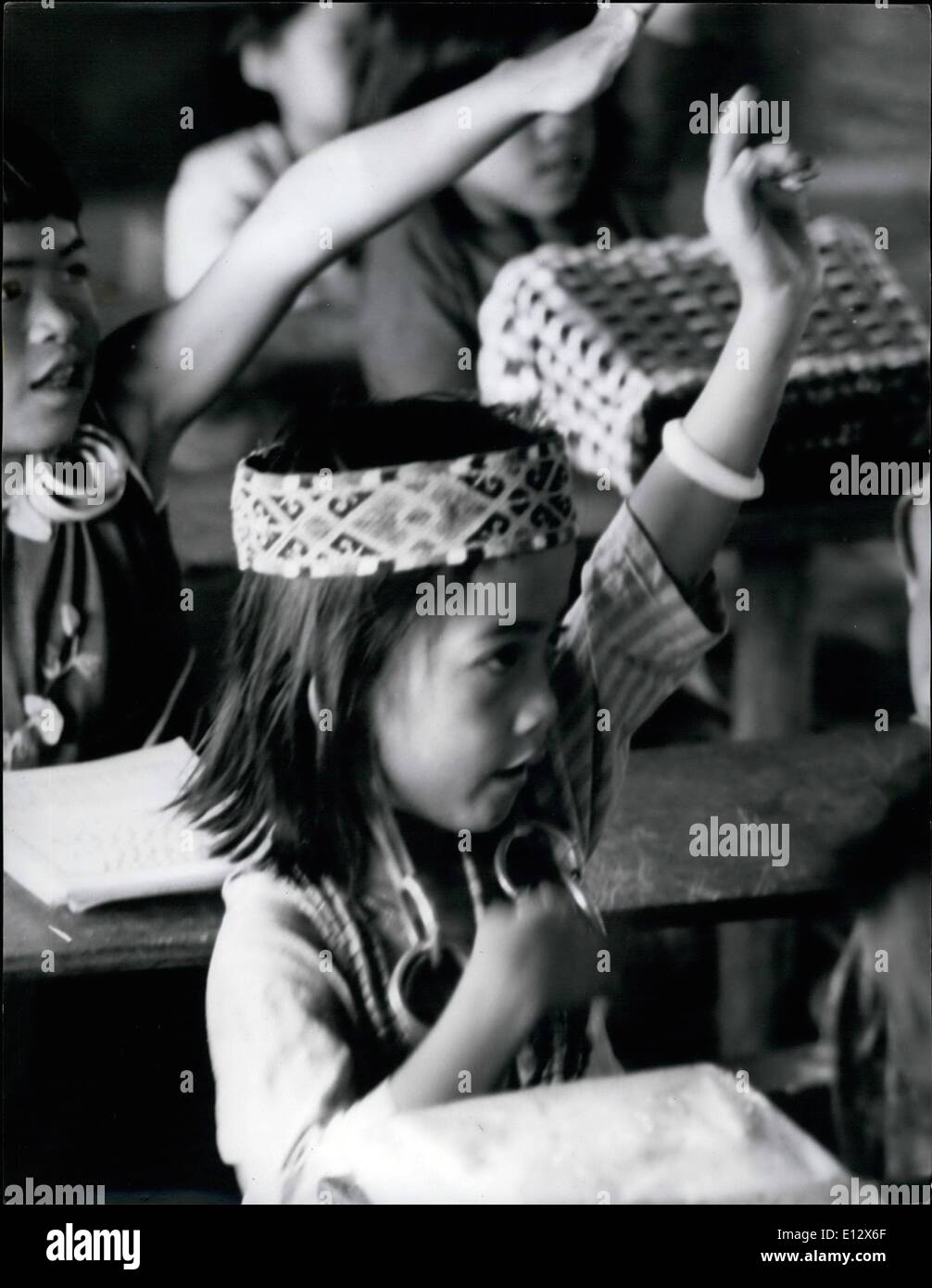 Feb. 25, 2012 - Drooping; Bejewelled Earlobes-And An Ex-Pupil At Ohio State Univ.: That's Sarawak's Jungle School A small girl sits demurely at her desk, her exercise book before her, hands in her lap, eyes fixed on her teacher-just like any other good pupil. but she has a beaded crown on her head, and her little ears are weighed down, drooping , decorated by a cluster of glittering heavy rings. And the classroom walls are bamboo, the windows air Stock Photo