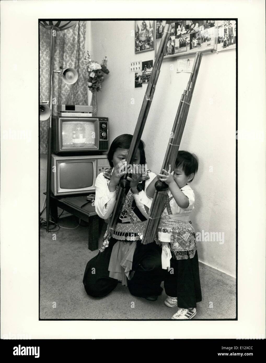 Feb. 26, 2012 - United States of America/Merced, Ca/Laotian refugees/Resettlement Adapting to their new life while maintaining their traditions: here, a Hmong ''Choukan'' or music man is teaching his son to play the flute. Stock Photo
