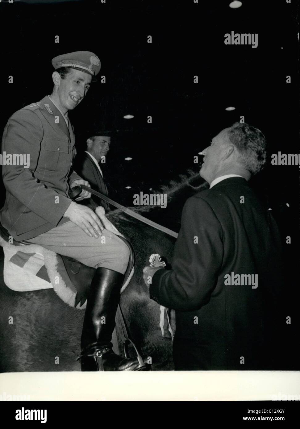 Feb. 25, 2012 - Raimondo D'Inzeo on his horse ''Merano'' receives his ribbons after winning the Grand Prix and the Prix de Longchamp last night during the international horse races. Sophia Loren, Scandal in Sorrento Premier, Paris Movie Theater Stock Photo