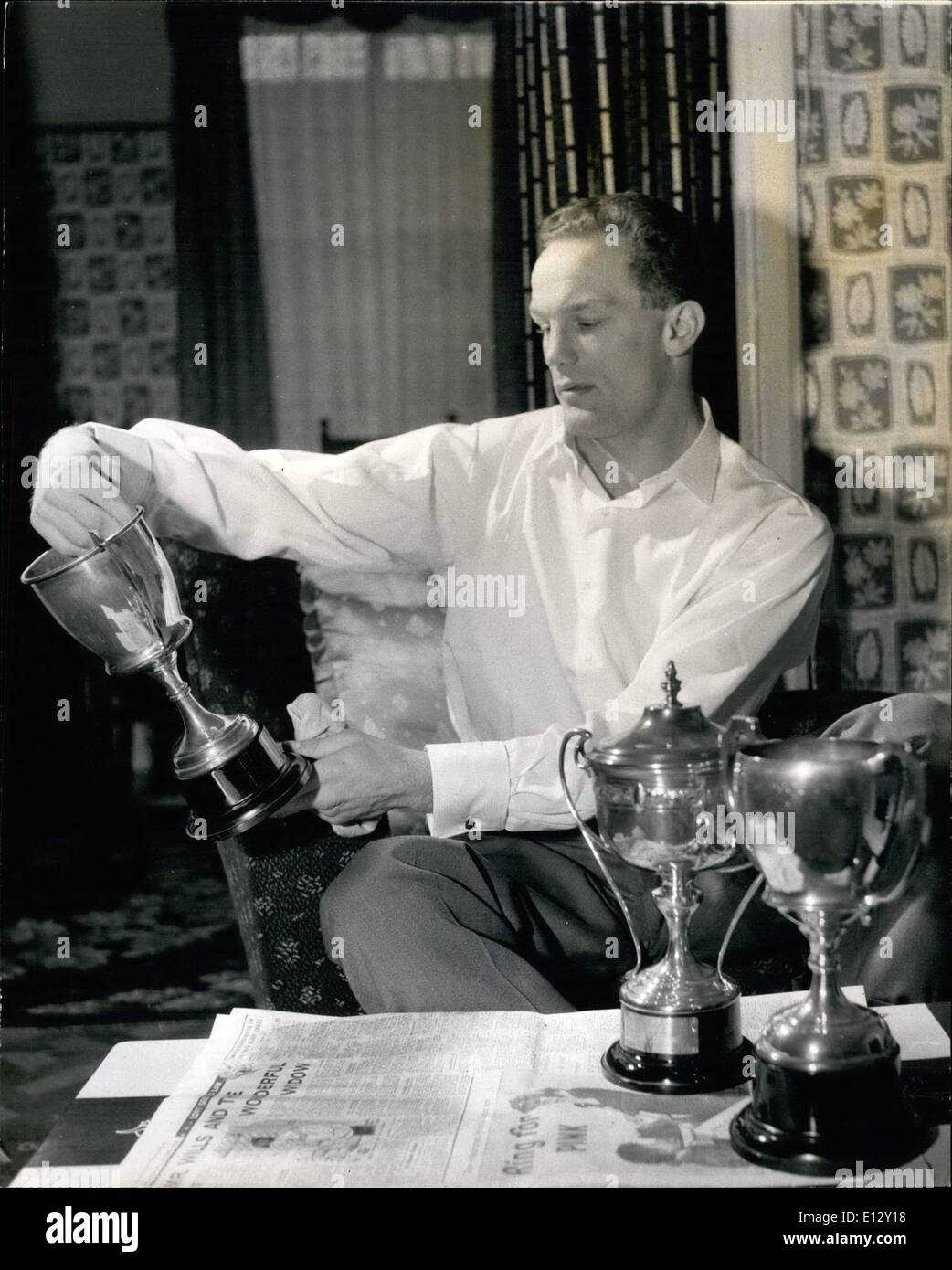 Feb. 26, 2012 - Henry Cooper cleans his own trophies in his home, sitting room. He and his twin brother, George, have a large collection won between them. Stock Photo