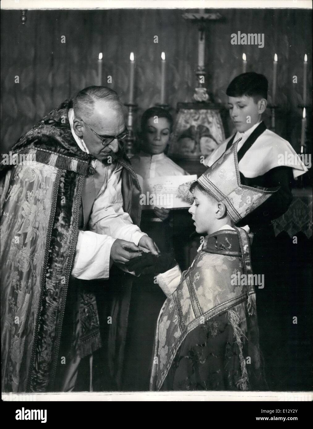 Feb. 26, 2012 - A Boy is mad a Bishop - for 23 days.: Thirteen - year - old Timothy Owen-Burke was made a Boy Bishop according to the centuries - old - custom and ceremonies, at S, Addlestone, Surrey, famous as a boarding school producing choristers known as ''Angels'', and run by the Rev.Desmond Morse-Boycott, a coasing of the Premier Annually the boys elect one of their number - he must however be able to get into the vestments, have a good voice and be of the very best character - for the ceremony and succeeding engagements which last until Holy Innocents Days Stock Photo