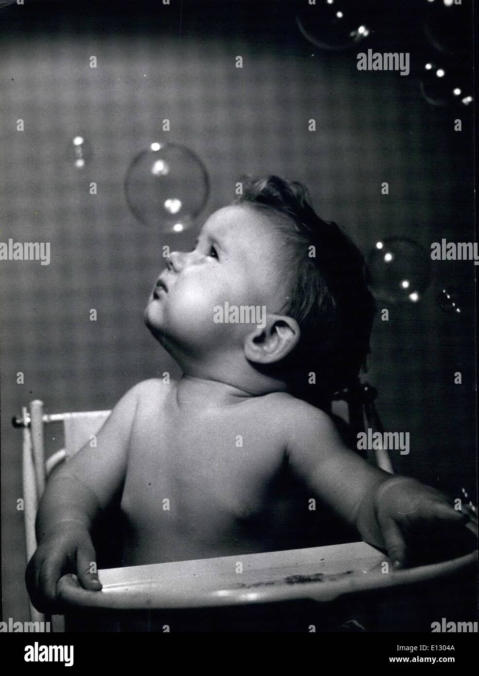Feb. 26, 2012 - There they go floating up to the ceiling. First they are one side then another. Watching bubbles is a full time Stock Photo