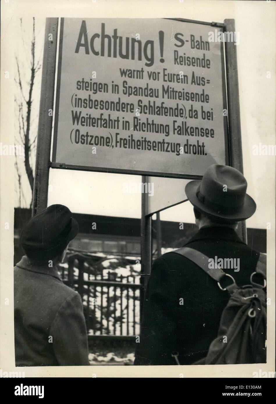 Feb. 25, 2012 - New warning notices for travellers in Berlin. The next station is in the Soviet zone. New warning notices have seen erected at Spandau West, the last electric railway station before the trains enter the Russian Zone. The notice warns travellers that if they rode on to the next station Falkensee they would be in the Russian zone and advising them to waken any travellers who were asleep as failure to do so might lose them their freedom. Keystone Photo Shows: Travellers reading the new warning before taking the electric trains at Spandau West, Berlin. Stock Photo