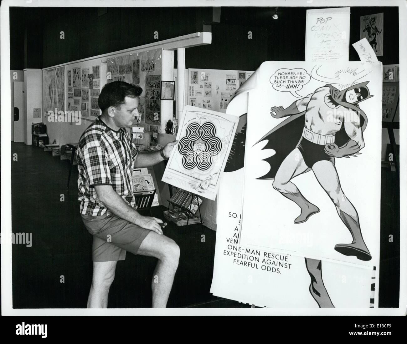 Feb. 26, 2012 - A poster of Batman by Bob Kane is viewed by Jim Ivey, owner of the Cartoon Museum, a new attraction that has opened at Madeira Beach on Florida's West Coast. The unusual museum has displays of original drawings of famous cartoonists from Ivey's collection of 2,500 works. Stock Photo