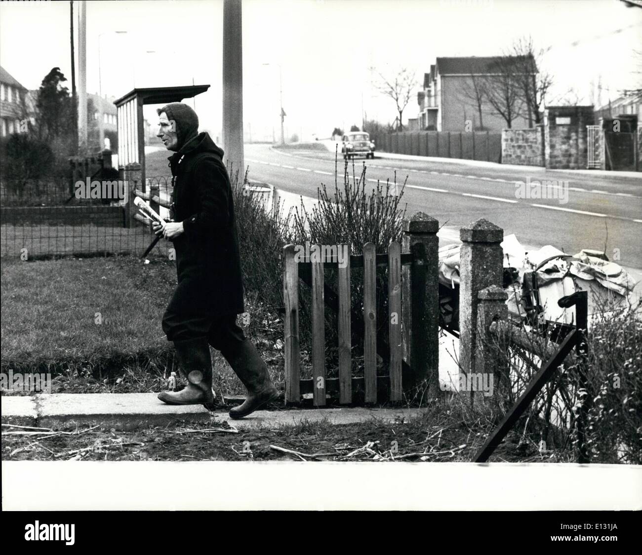 Feb. 26, 2012 - With the bike parked. Alan makes a delivery on his morning 20 mile newspaper round. Stock Photo