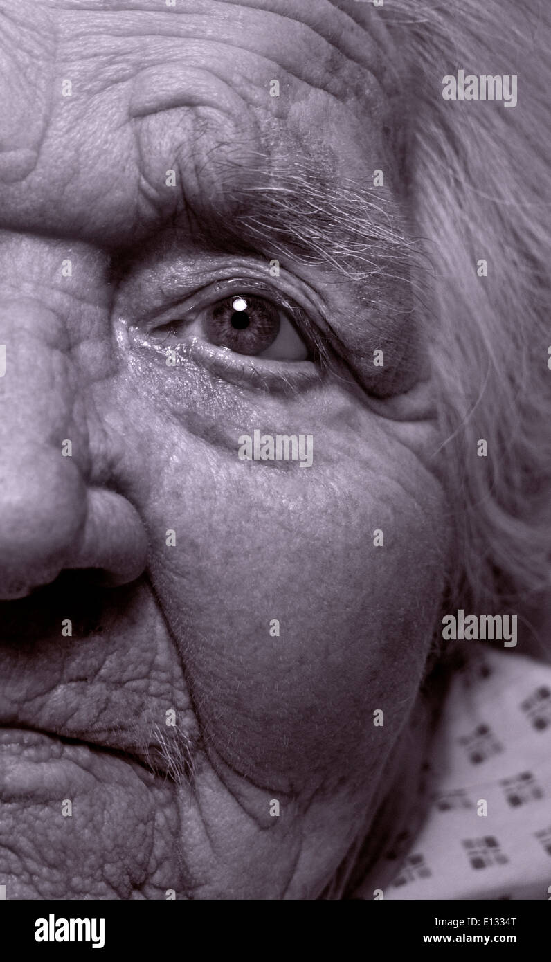 OLD ELDERLY EYE Close view on elderly vulnerable 100 years old senior lady (B&W toned RGB treatment) Stock Photo
