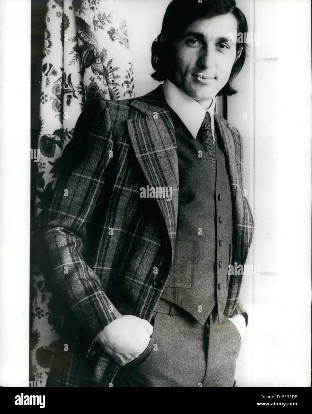 Feb. 28, 2012 - Nasty - The Model: Ilie Nastase, The Rumanian tennis star who is noted for showing off on the tennis court, is seen here showing off the fashions of the famous French tailor Guy Laroche, for the fourthcoming Autumn/Winter. Ilie is seen here wearing a three-place flannel suit, the jacket Scottish style in yellow, green and orange design on plain grey, with the hand-sewn trousers and waistcoat in becoming pastel grey. Stock Photo