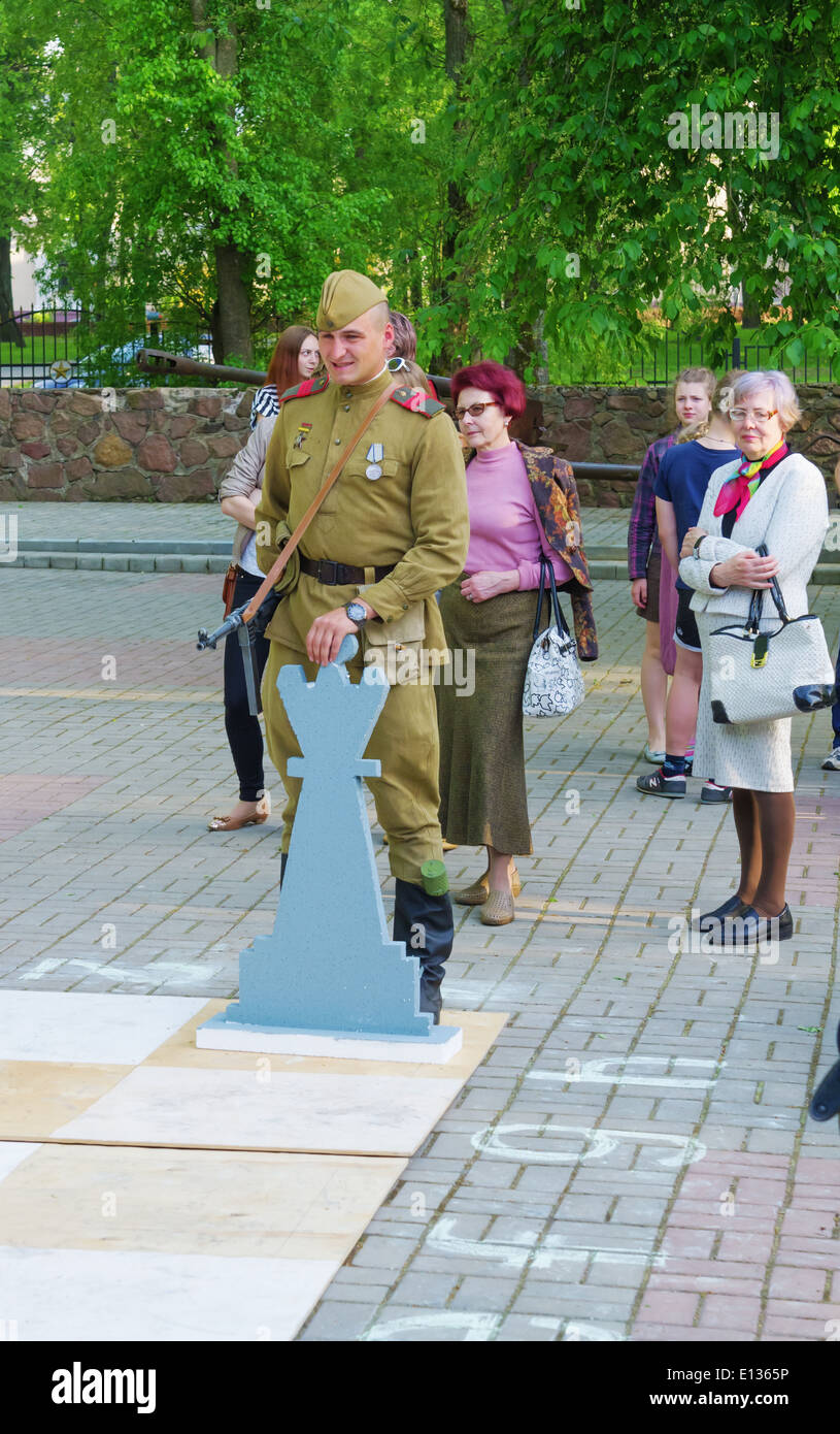 The Live Chess tournament on the imitating a chessboard, where actors from museum military club and guests acted with figures. Stock Photo