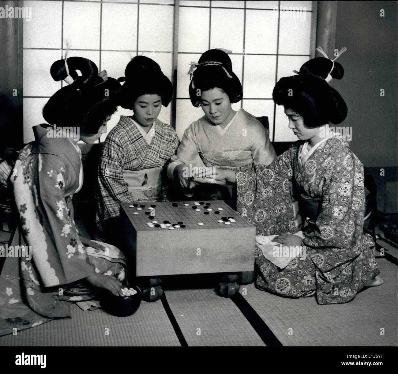 Feb. 28, 2012 - Japanese Geisha girls find the game of ''Go'' entertaining and time-passing. Although only two can play, there's no limit to the number who can watch and offer advice. Stock Photo