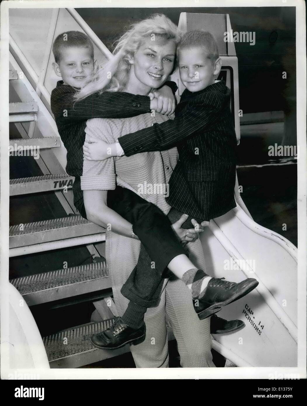 Feb. 29, 2012 - Irish McCulla, TV's Sheena, Carries her sons, Kim, 9, Left, And Sean, 5, Jungle-style prior to boarding a TWA Jetliner To their home in Los Angeles. They arrived in Town earlier in the day from a month long vacation in Europe. Stock Photo