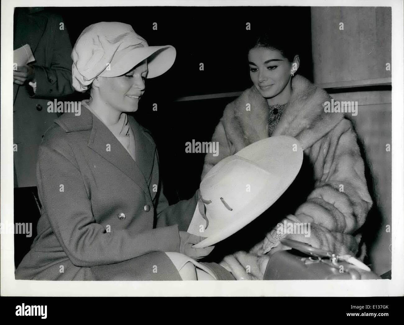 Feb. 29, 2012 - 18.14.59 Film Stars Leave for Canary Islands. Film stars, including Eva Bartok, Pier Angeli, Richard Attenborough and John Gregson, left Gatwick Airport today for the Canary Islands, for location shooting of the film S.O.S. Pacific . Keystone Photo Shows: Eva Bartok admires Pier Angeli's straw sun hat, which Miss Angeli carries every where, as a sort of mascot prior to their departure from Gatwick today. Stock Photo