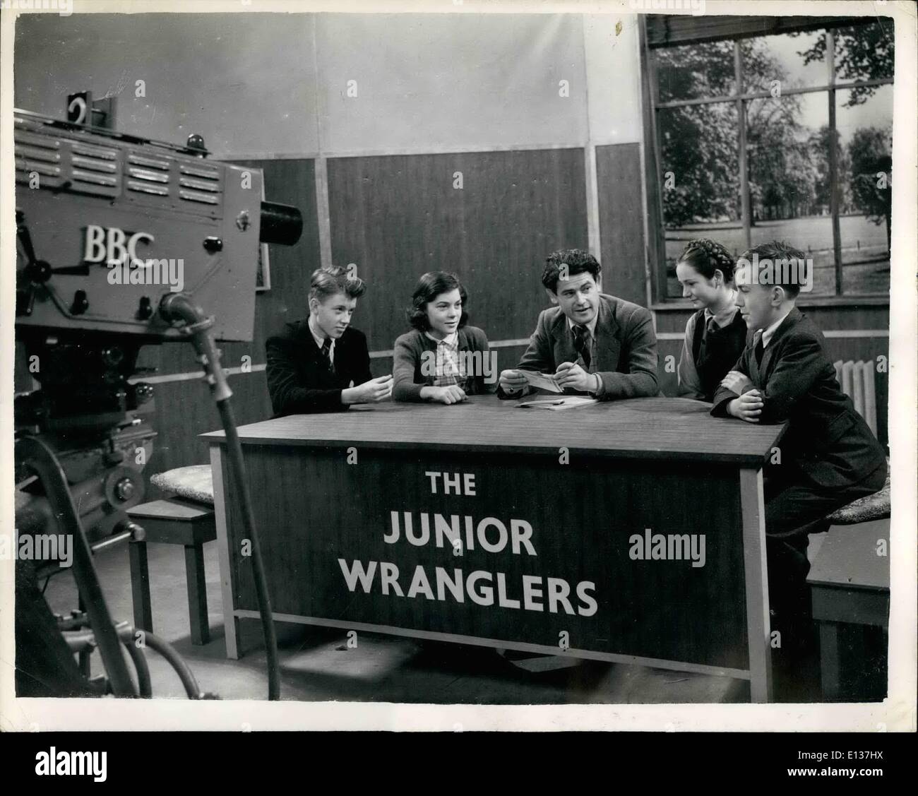 Feb. 29, 2012 - The ''Junior Wrangler'' of the B.B.C. New Children's Hour ''quiz'' programme.: The new B.B.C. Children's Hour television Programme ''Junior Wrangler: = went on the air for the first time this evening. The 'wranglers' are selected for each programme from twenty-five boys and girls. Two boys - and two girls meet each other before the TV cameras and debate questions sent in by viewers - under the chairmanship of Humpray Lestooq. Photo shows the four 'wranglers'' - and the questions master - during the quiz this evening Stock Photo