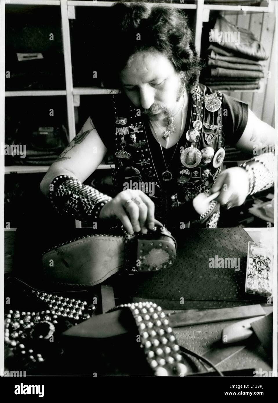 Feb. 29, 2012 - It was a hard work for a hard man : To finish his leather-jacket. James Schroder, 29 needed more than 8000 rivets and glittering stones for his work. When he started hammering the rivets for the jacket it was a hobby for James, but now his hobby became his profession: in a shop on Hamburg's world famous reeperbahn James hammers for other people who love rivets and leather (our picture). They have to pay for one rivet one mark, for a glittering stone 1.20 mark. He is riveting everything, even bras Stock Photo