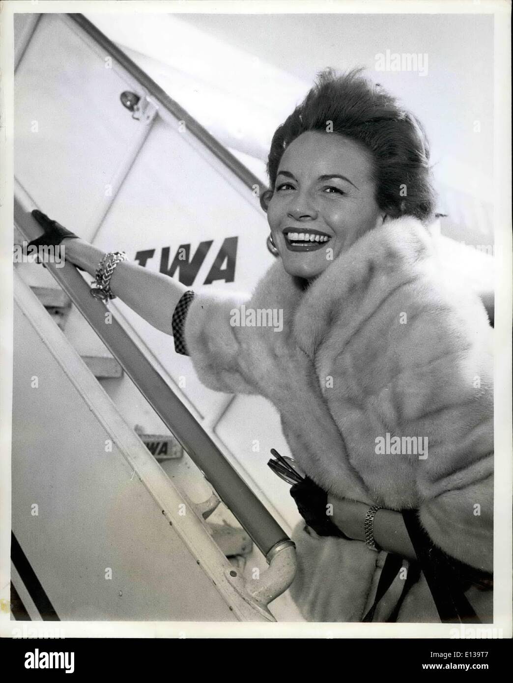 Feb. 29, 2012 - N.Y. International Airport, Nov. 22. Wind blown TV star Janet Blair is caught by photographer as she rushes up the ramp of a TWA jetliner bound for Los Angeles. The pink clad star will head up next Sunday's Chevy show. Stock Photo