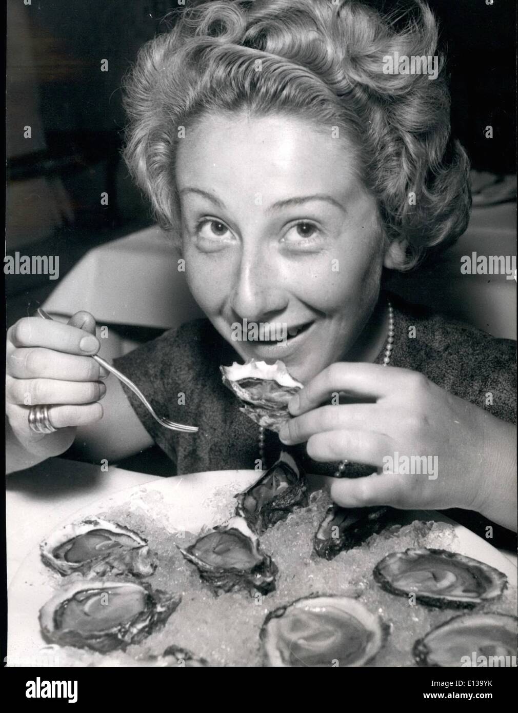 Feb. 29, 2012 - THE BEGINNING OF THE OYSTER SEASON IN FRANCE: THIS YOUNG PARISIAN LADY SEEMS TO ENJOY THE FIRST OYSTERS OF THE SEASON. Stock Photo