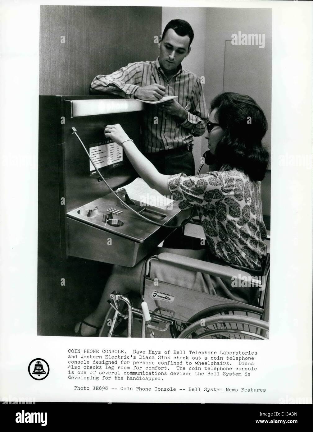 Feb. 29, 2012 - Coin Phone Console: Dave Hays of Bell Telephone Laboratories and Western Electric's Diana Sink check out a coin Stock Photo