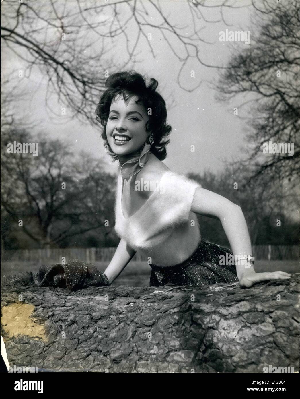 Feb. 29, 2012 - .............And Spring Can't Be Far Away......: Mara Lane, British Star just back from Hollywood, has a rest on one of the fallen elms in the Park. Stock Photo