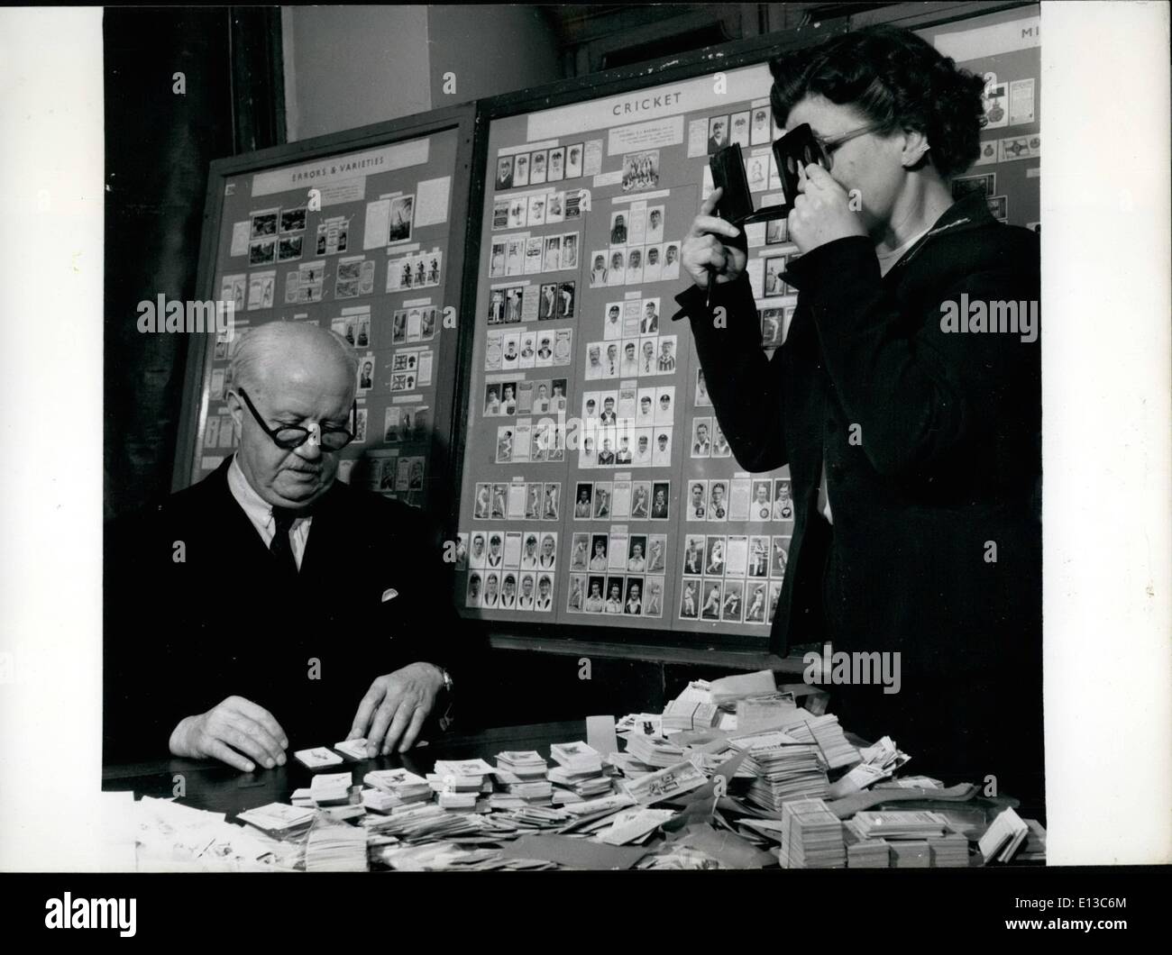 Feb. 29, 2012 - Colonel Bagnall is a cigarette card King: The colonel and his daughter examine pre-war American stereoscopic cigarette cards. In the background are some of his display cards. Stock Photo